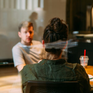 Looking through window at 2 people talking